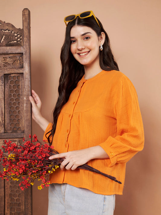 Left-side view of orange cotton top showing sleeve detail