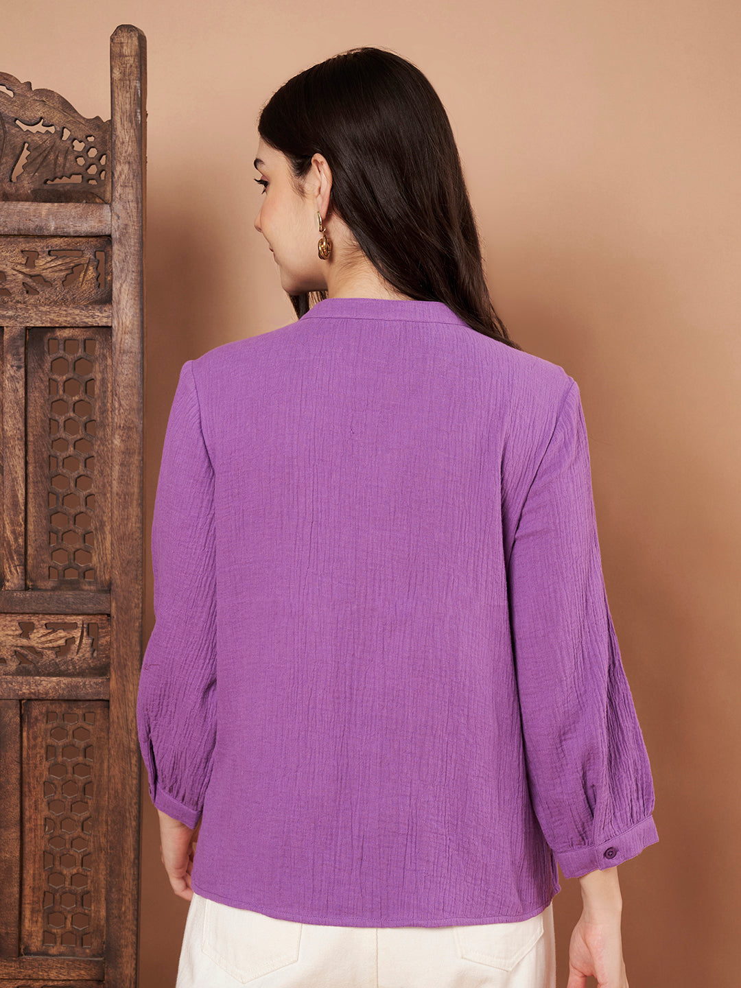 Close-up of button-down detail and cotton fabric on purple top
