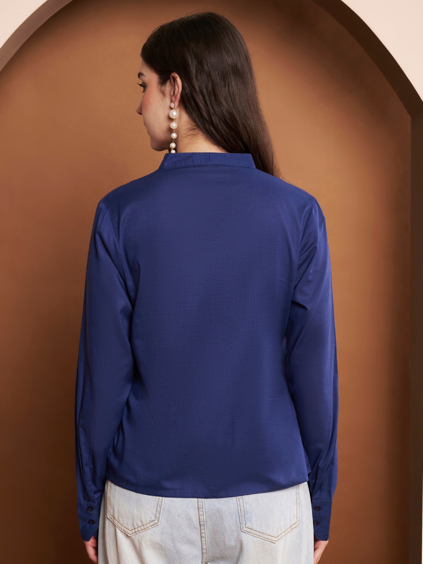 Back view of womenβs navy blue pleated cotton v-neck top