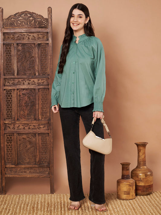 Front view of green cotton button-down shirt with ruffle neck detail for women