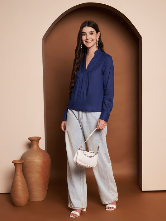 Model wearing a navy blue pleated cotton v-neck top